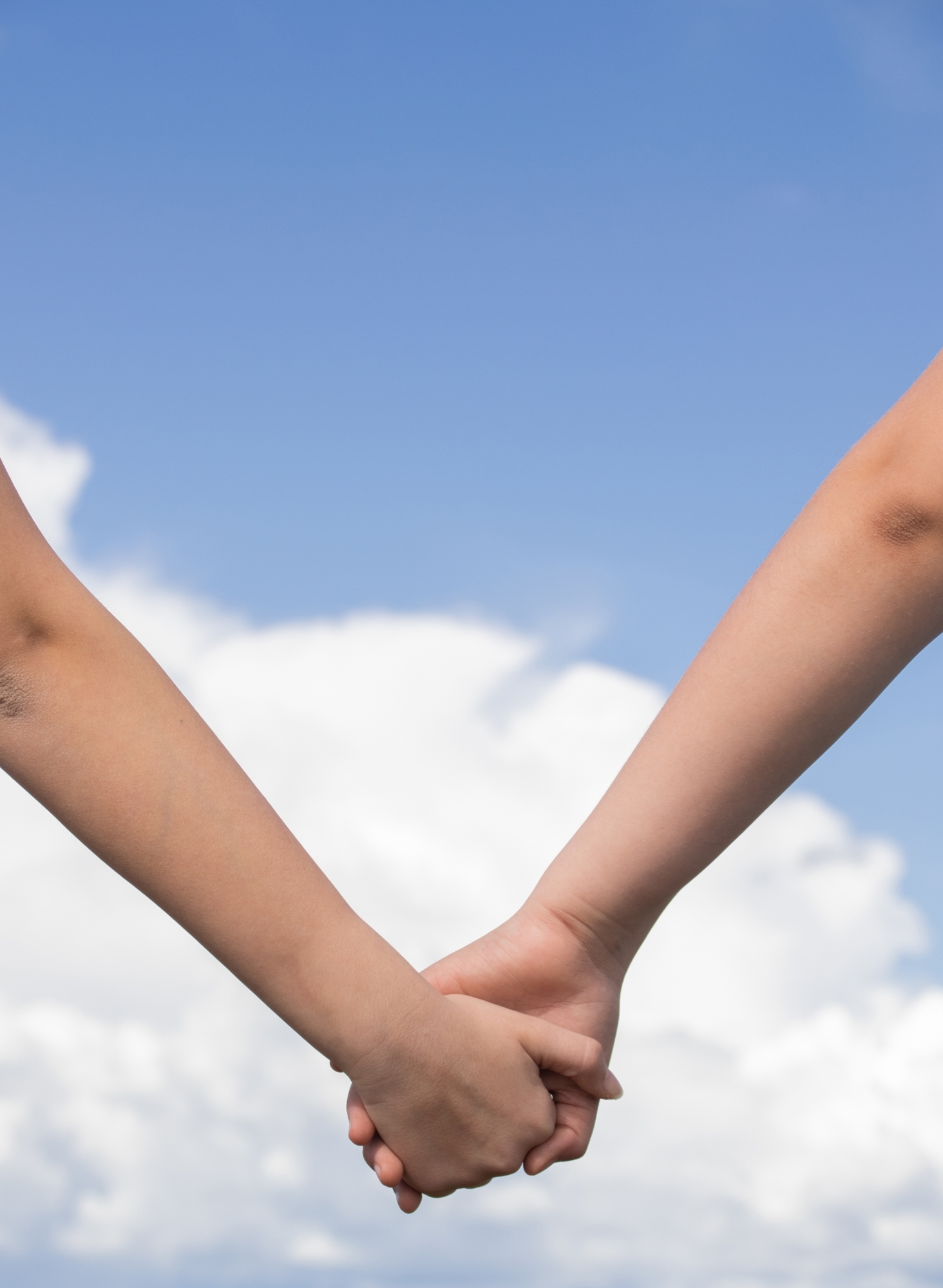 Low-angle-shot-two-people-holdings-hands-together-friendship-love-concepts