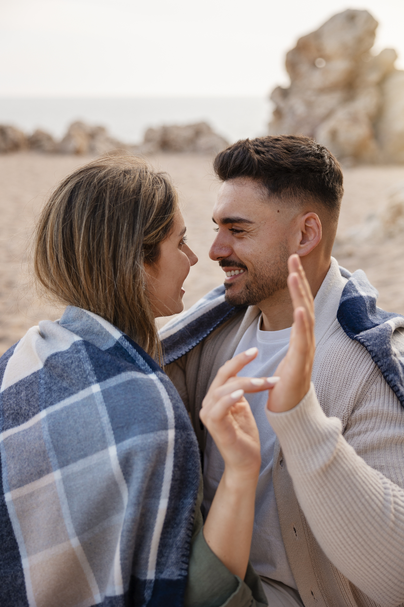 Medium-shot-romantic-couple-with-plaid-blanket