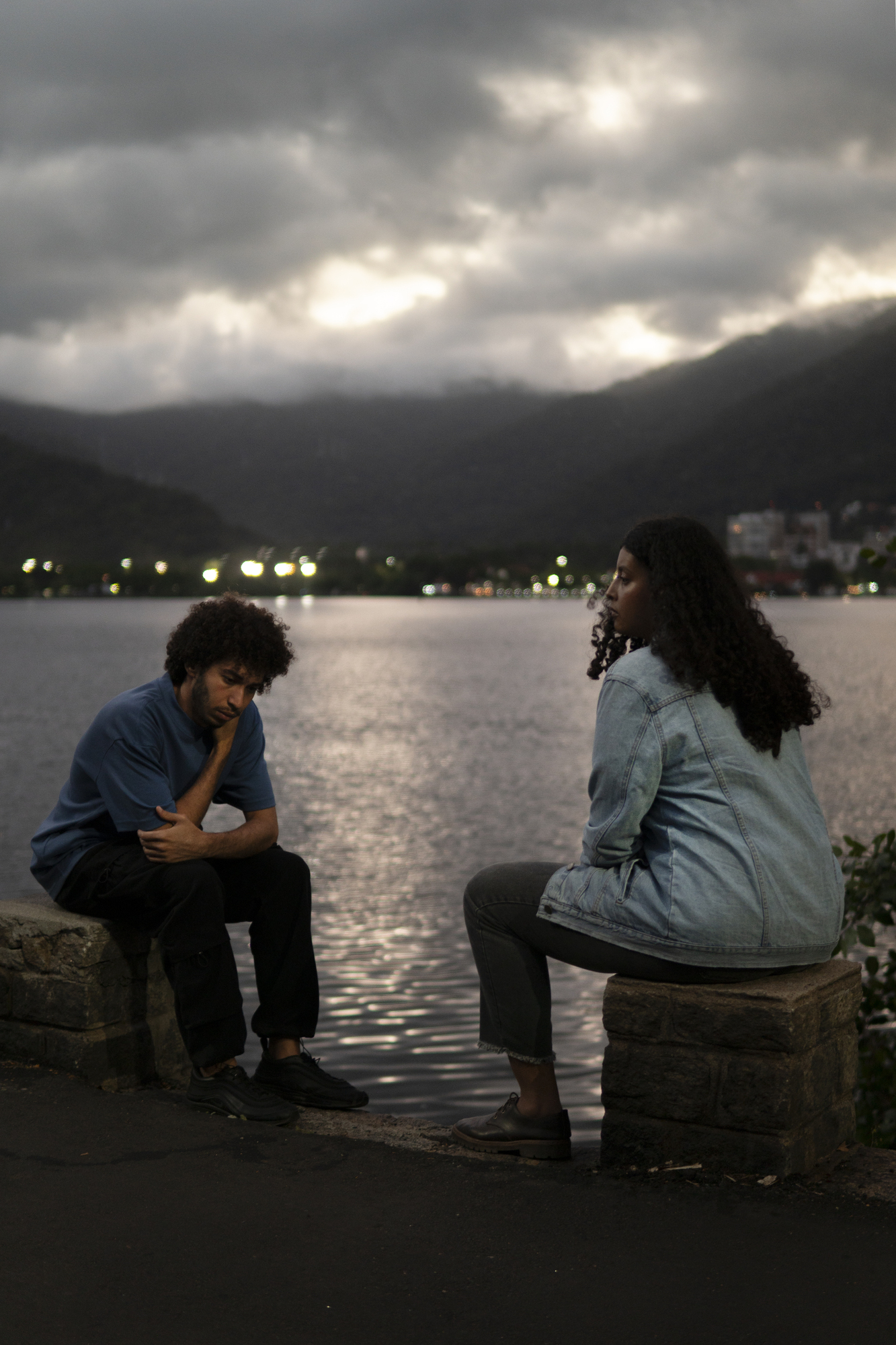 Sad-couple-sitting-together-outdoors
